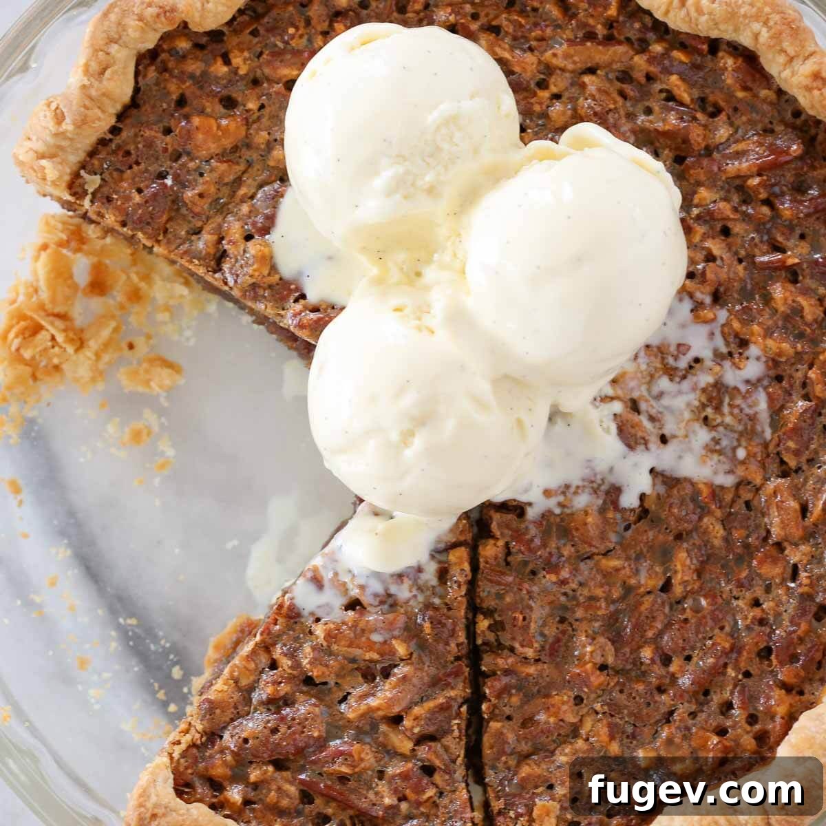 Whiskey-Kissed Pecan Dream 9 A stunning Bourbon Pecan Pie, artfully sliced in its dish, accompanied by generous scoops of vanilla bean ice cream, inviting indulgence.