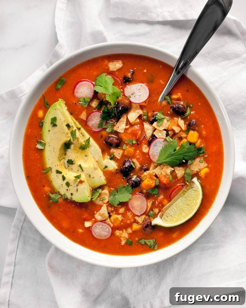 Fiesta in a Bowl 4 Three beautifully arranged bowls of tortilla soup, garnished with fresh cilantro, lime, and radishes, inviting diners to enjoy.