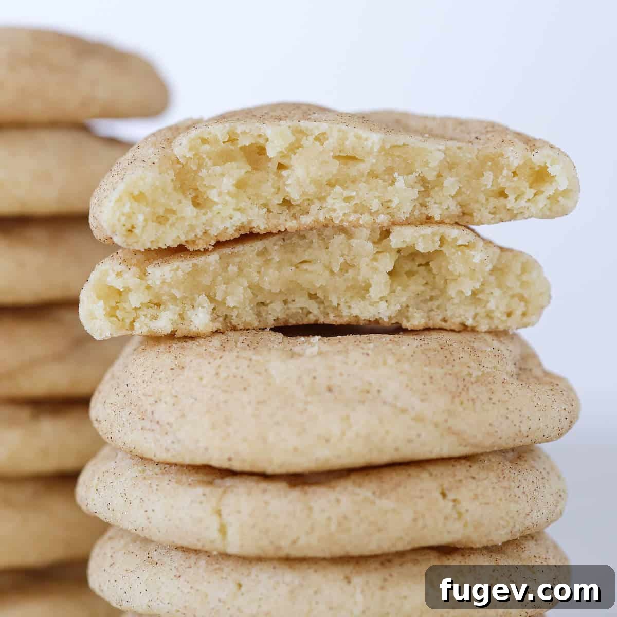Your New Favorite Snickerdoodle Recipe 3 Snickerdoodles broken open to reveal their soft interior and stacked beautifully.