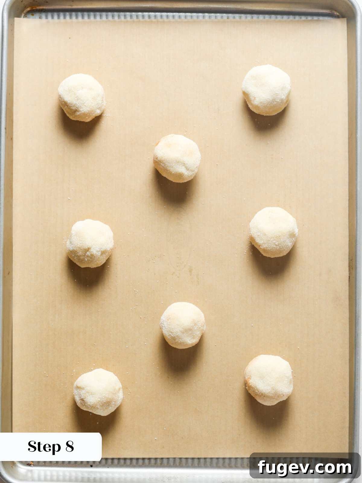 Your New Favorite Snickerdoodle Recipe 10 Snickerdoodles arranged on brown parchment paper, ready to be baked.