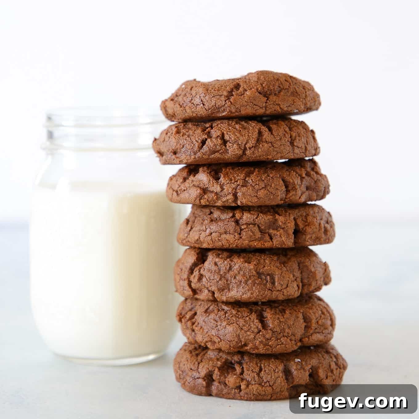 Pure Double Chocolate Bliss 4 double chocolate chip cookies next to a glass of milk.