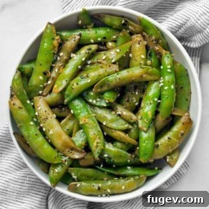 Sautéed snap peas in a bowl.
