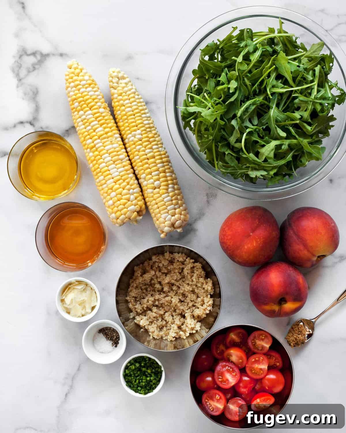 Sweet & Smoky Grilled Peach and Corn Salad 3 Ingredients laid out including corn on the cob, fresh peaches, a bowl of arugula, a bottle of olive oil, white balsamic vinegar, and cooked quinoa.