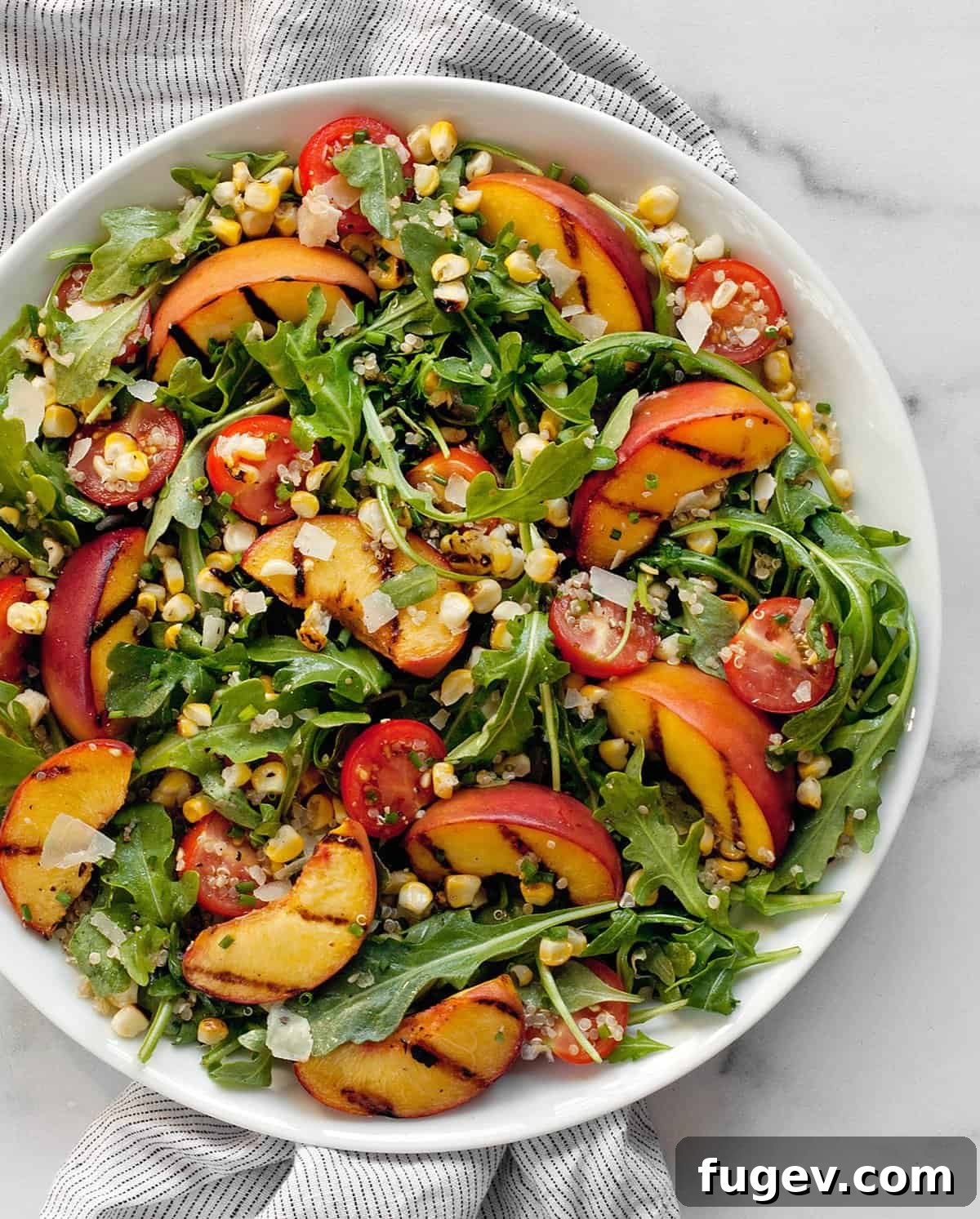 Sweet & Smoky Grilled Peach and Corn Salad 7 Grilled peach salad with corn on a plate, ready to be enjoyed.