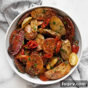 A vibrant bowl of Roasted Tomato Pesto Potato Salad, showcasing the golden potatoes, blistered tomatoes, and green pesto.