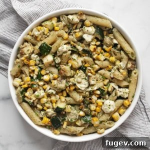 Grilled zucchini corn pasta with mint pesto in a bowl.