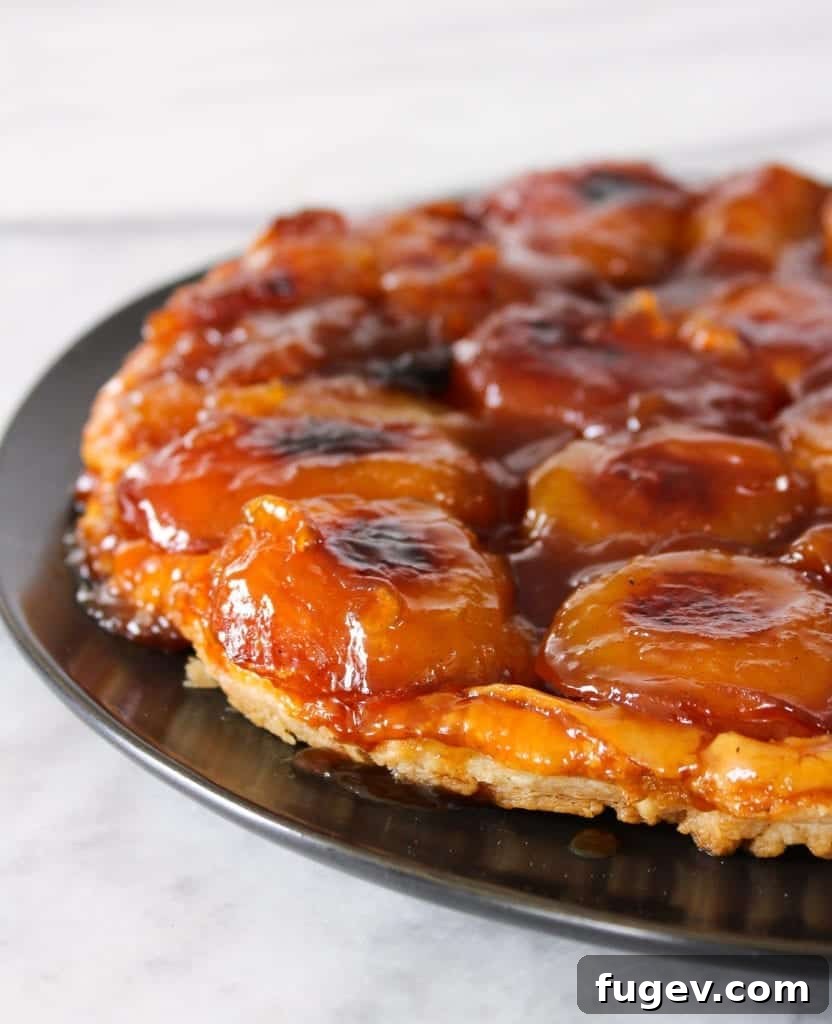 Caramelized Apple Upside Down Tart 3 Golden brown Apple Tarte Tatin with caramelized apples arranged beautifully on top, ready for serving.
