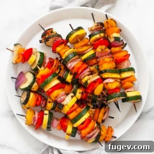 Balsamic grilled vegetable skewers on a plate.