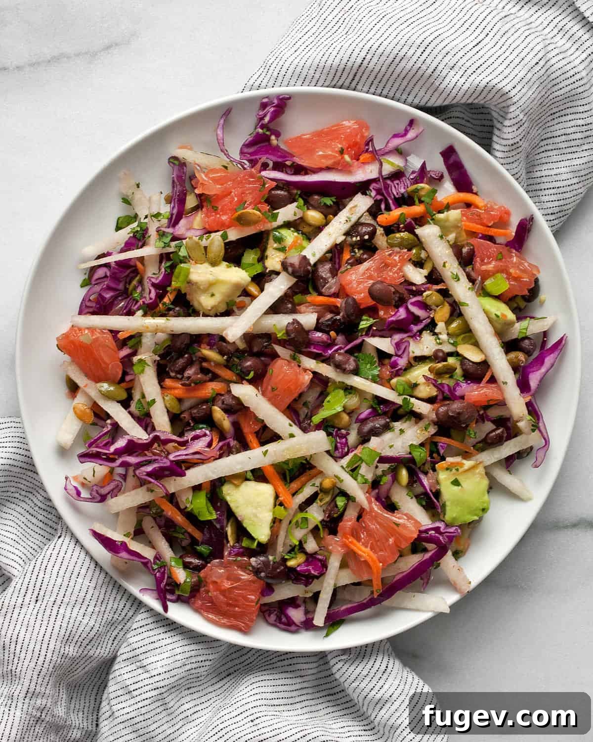 Zesty Jicama Crunch Salad with Black Beans and Cabbage 6 A small plate showcasing a portion of the vibrant jicama salad, highlighting its appealing presentation.