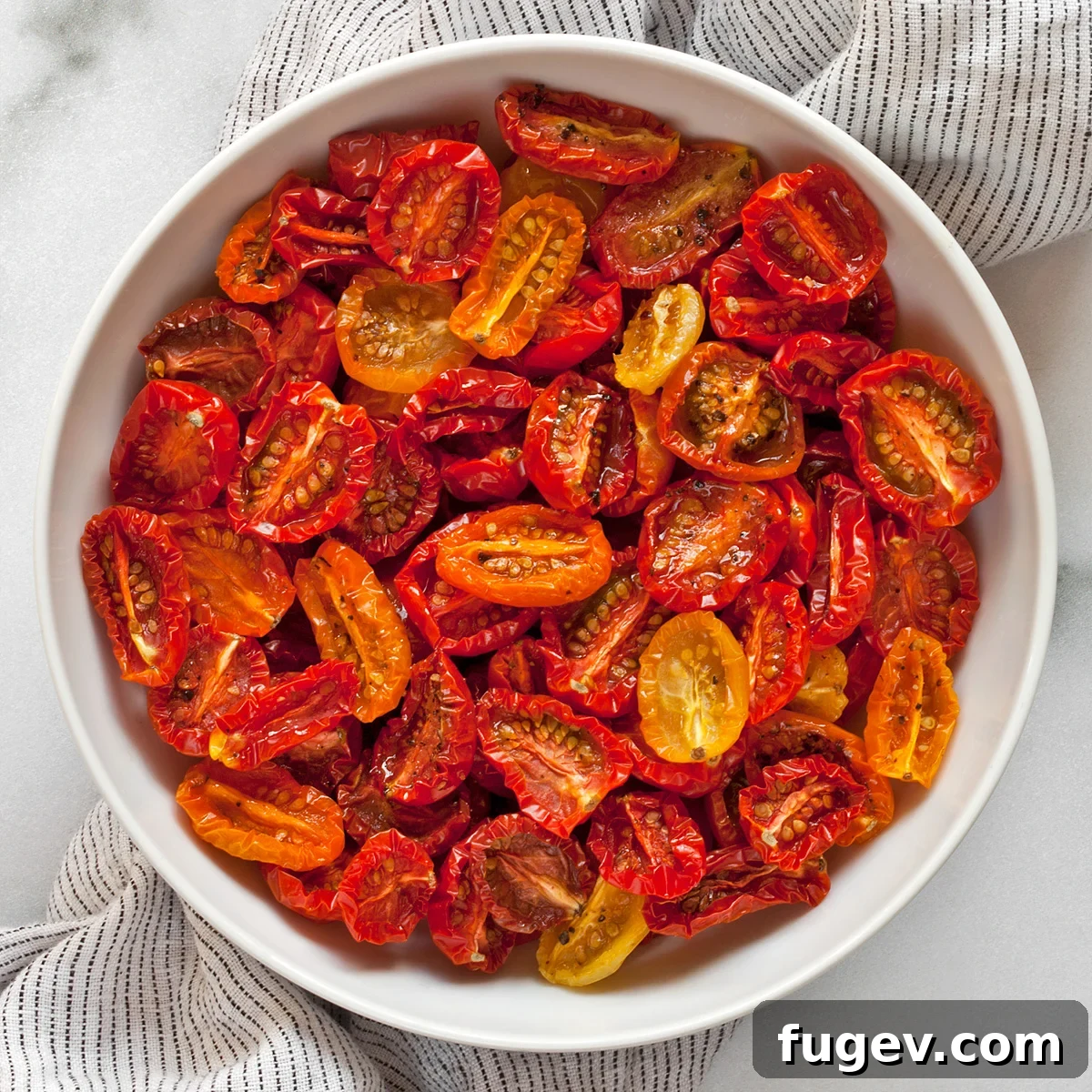 Golden Slow-Roasted Tomatoes 2 A bowl filled with perfectly slow-roasted tomatoes, glistening with olive oil.