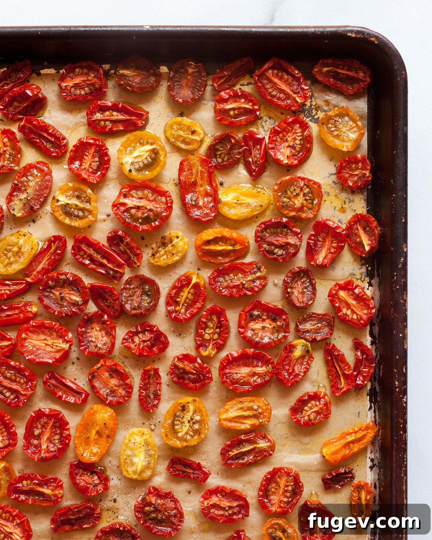 Golden Slow-Roasted Tomatoes 6 A sheet pan generously covered with a fresh batch of slow-roasted tomatoes, showcasing their rich color and tender texture.