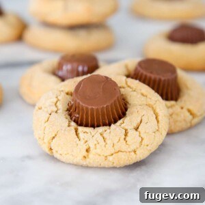 Close up of a Peanut Butter Cup Cookie showing the soft Reese's center