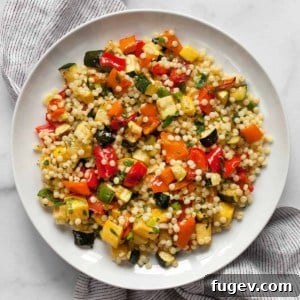 Roasted vegetable couscous on a plate, ready to be served.