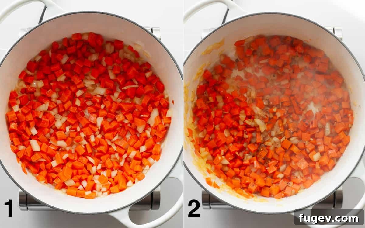 Finely chopped onions and diced carrots sautéing in olive oil in a large pot, with spices and minced garlic recently added and stirring to become fragrant.