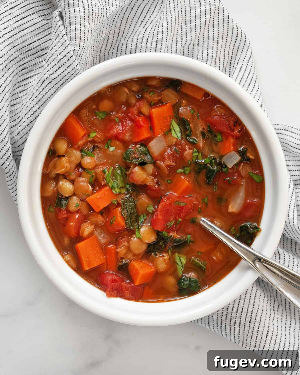 A single bowl of vibrant green lentil soup, garnished with fresh parsley, highlighting its rich texture and inviting warmth.