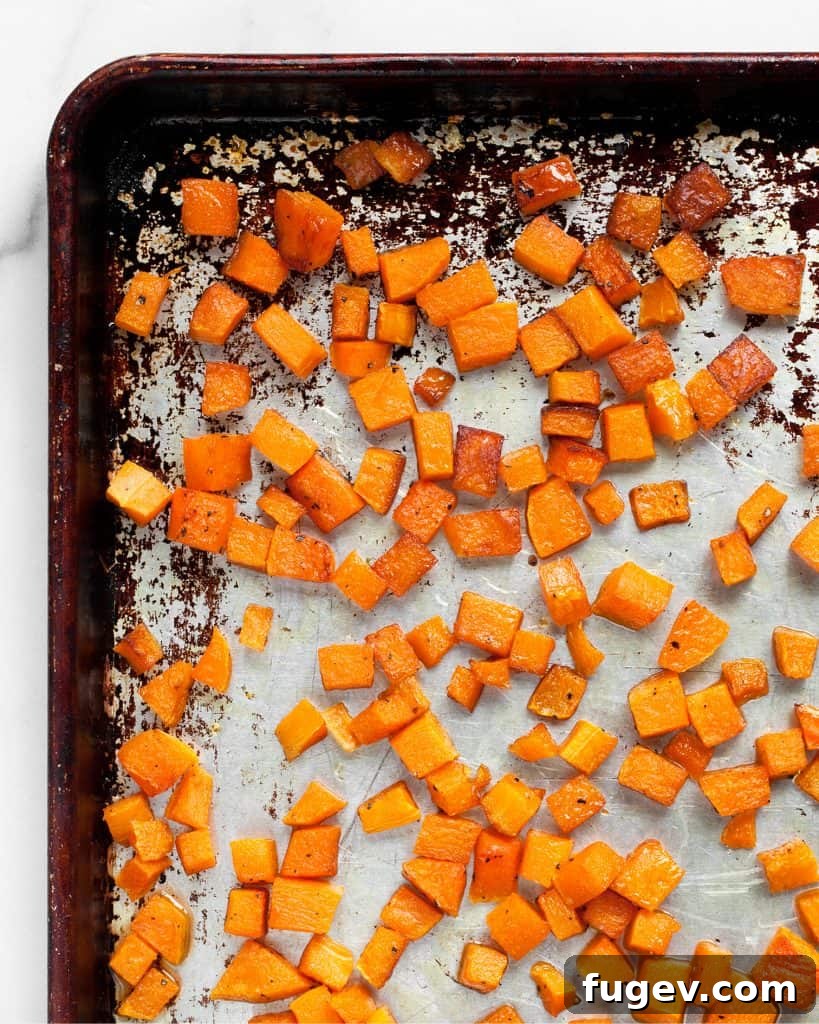 Caramelized Butternut Pizza 4 Close-up of roasted butternut squash pizza with fresh ingredients.