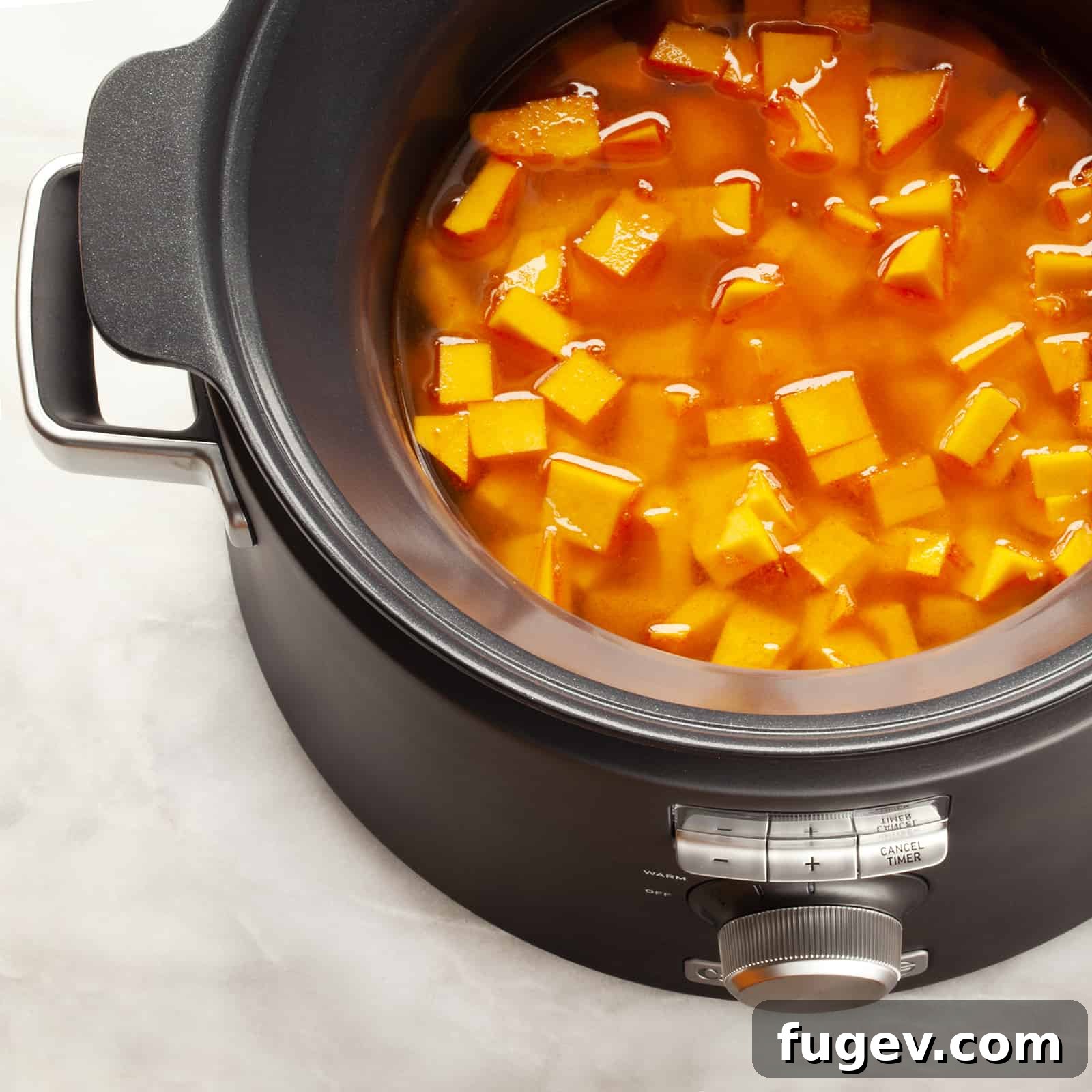 Velvety Slow Cooker Butternut Curry 3 Preparing ingredients for Slow Cooker Curried Butternut Squash Soup in a modern kitchen