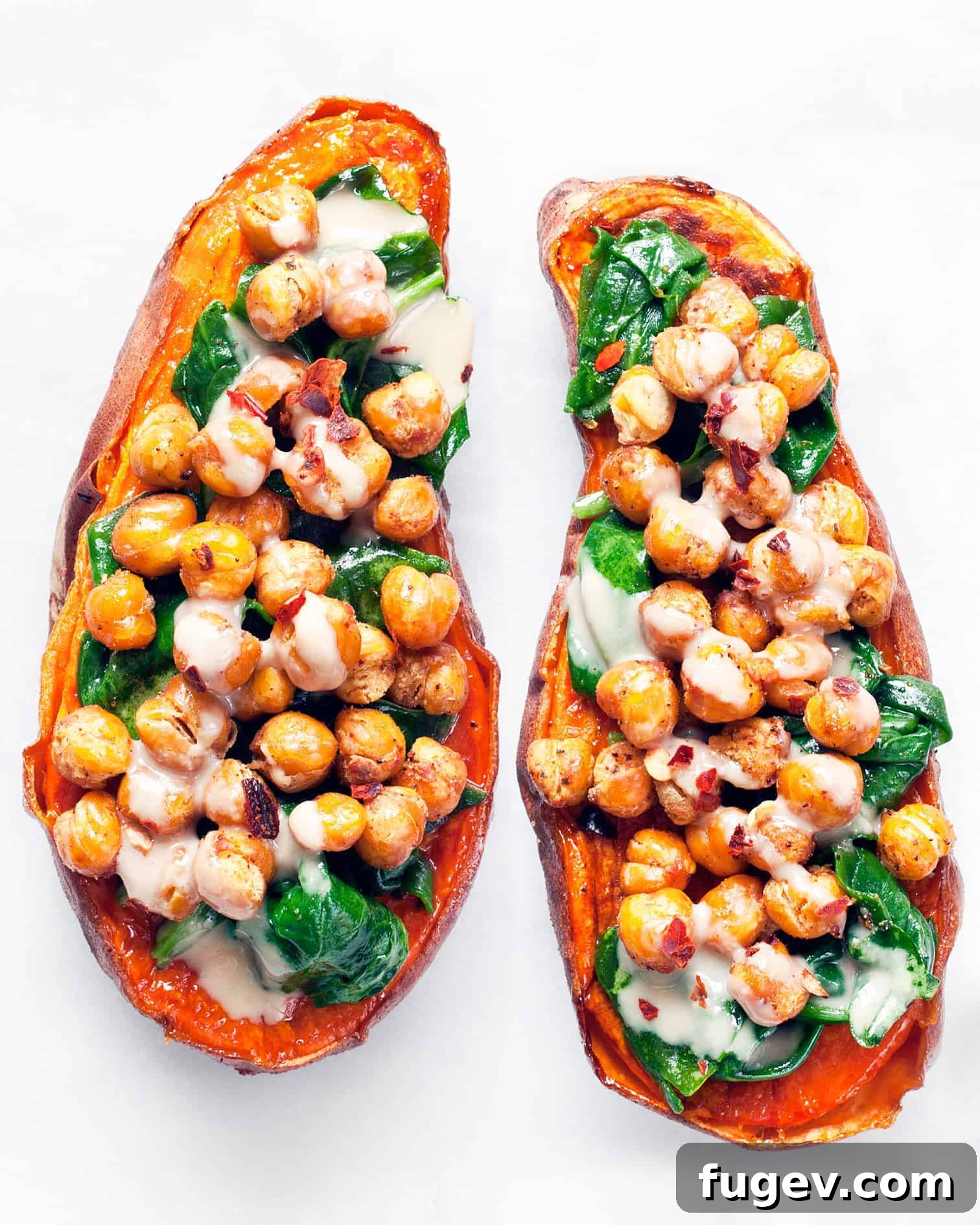 Savory Chickpea and Spinach Stuffed Sweet Potatoes 2 Chickpea spinach stuffed sweet potatoes, drizzled with tahini and red pepper flakes.