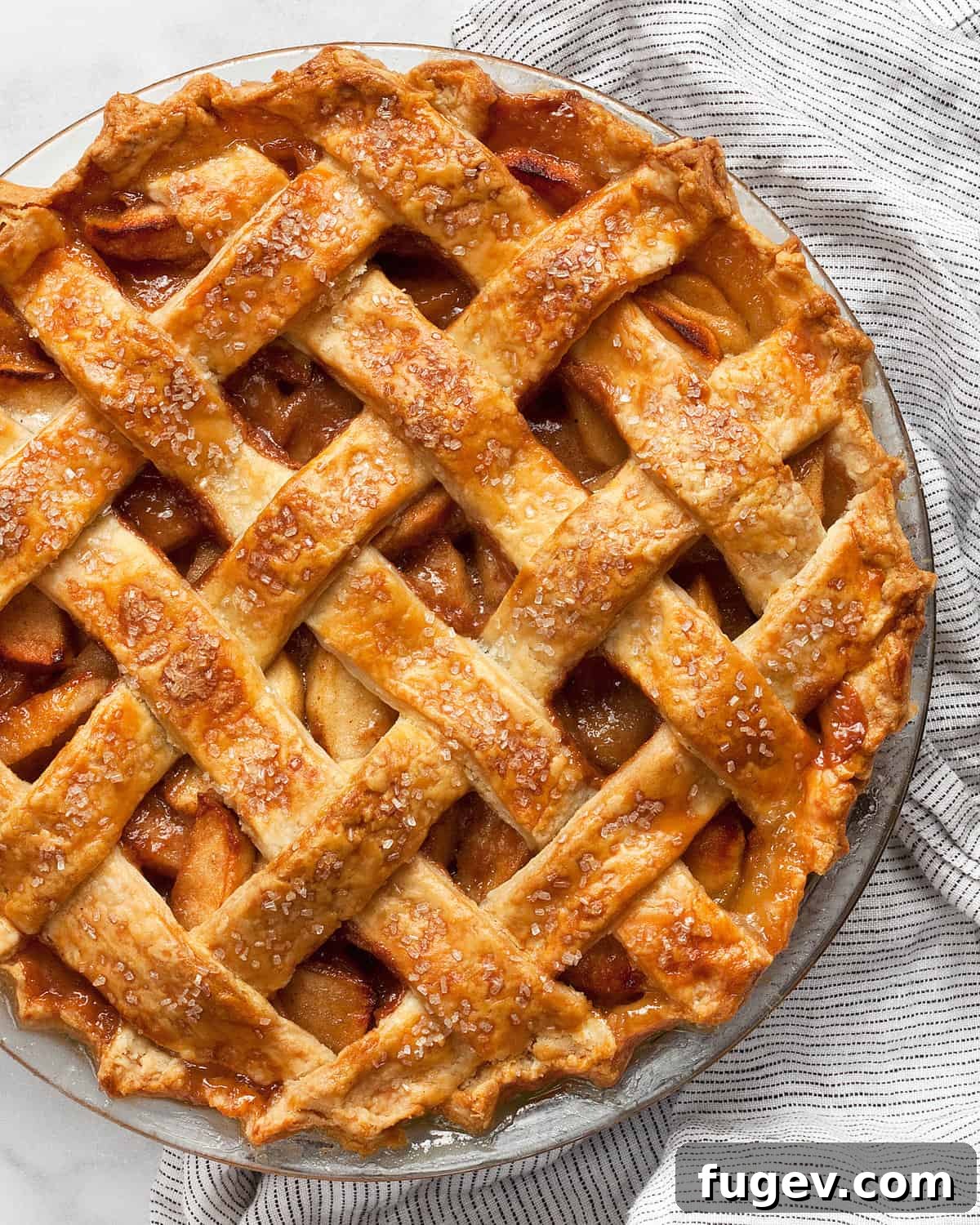 Salted Caramel Apple Crumble Pie 2 A perfectly baked salted caramel apple pie in a rustic pie dish, ready to be sliced.