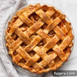 A slice of delicious apple pie in a dish with a golden crust and warm filling.