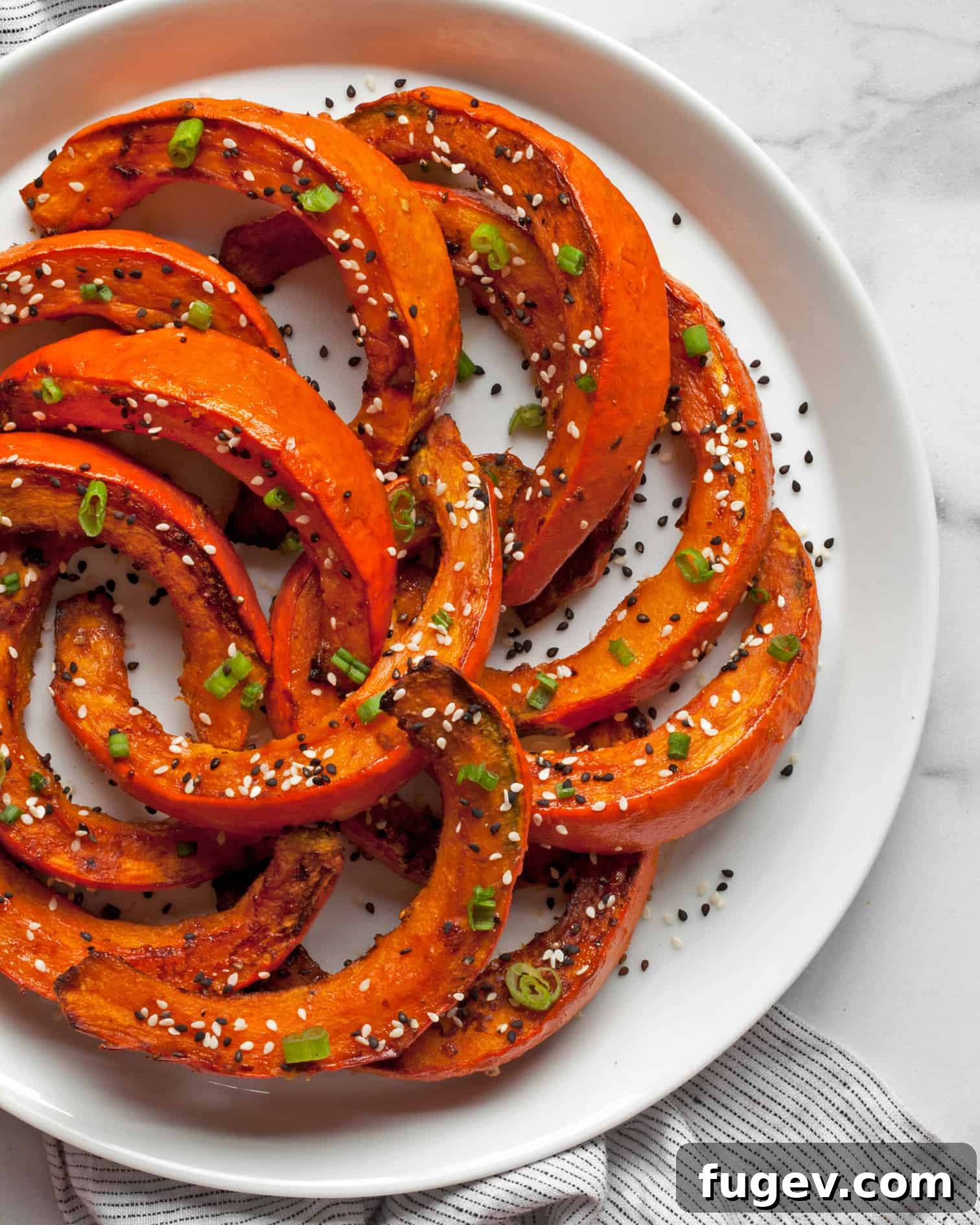 Umami-Glazed Crimson Kuri Squash 2 Miso-Glazed Red Kuri Squash, beautifully roasted and garnished, ready to be served.