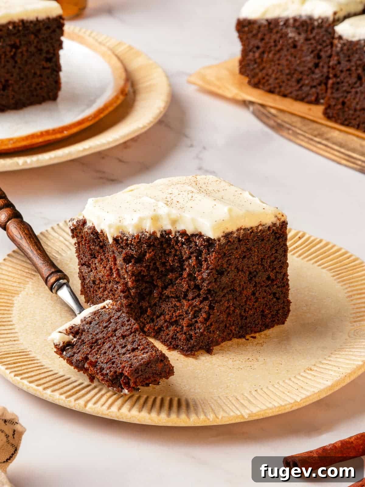 Warm Spiced Gingerbread 2 Fork holding a bite of gingerbread cake on the plate to show texture clearly. The cake is moist and light brown.