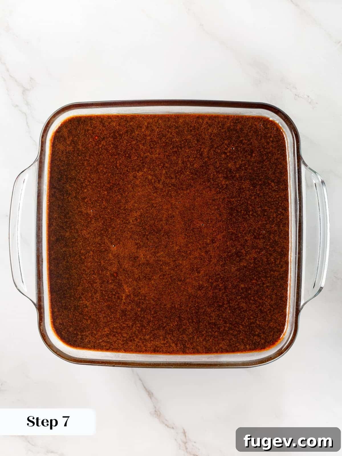 Warm Spiced Gingerbread 11 Gingerbread cake batter being poured into a rectangular baking dish lined and prepared.