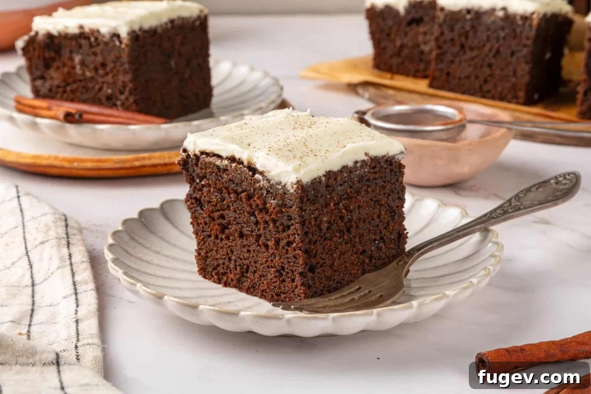 Warm Spiced Gingerbread 5 Single gingerbread cake square on a small plate highlighting fluffy interior and dark brown crumb.