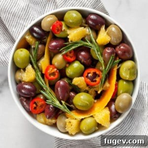 Citrus and herb marinated olives in a bowl, a perfect party appetizer.