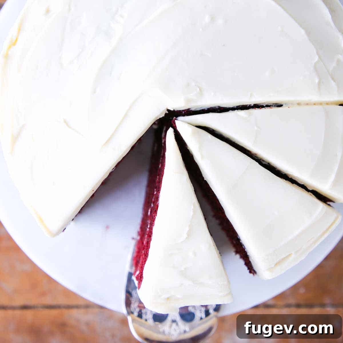 Lush Cream Cheese Buttercream 4 A slice of red velvet cake adorned with bourbon cream cheese buttercream.