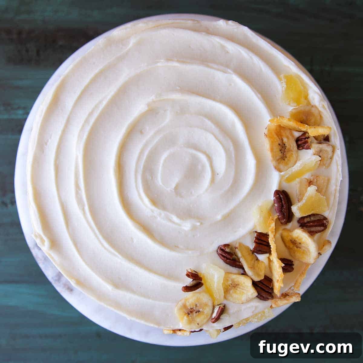 Lush Cream Cheese Buttercream 8 An unsliced cake with beautifully swirled cream cheese buttercream on top.
