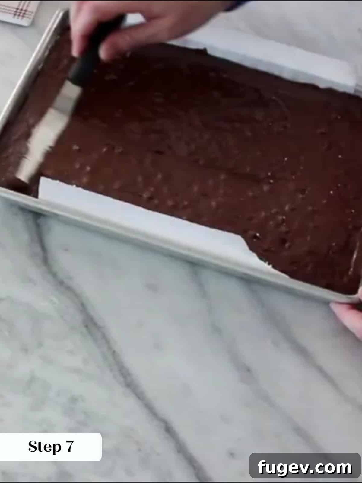 Peppermint Fudge Brownies 13 Thick, glossy brownie batter spread evenly into the prepared baking pan using an offset spatula.