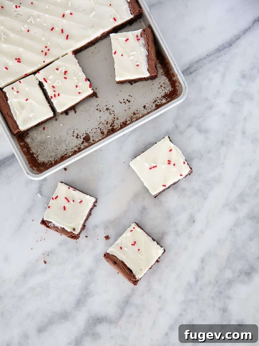 Peppermint Fudge Brownies 19 Artfully arranged peppermint brownies on a elegant marble countertop, highlighted by natural light.