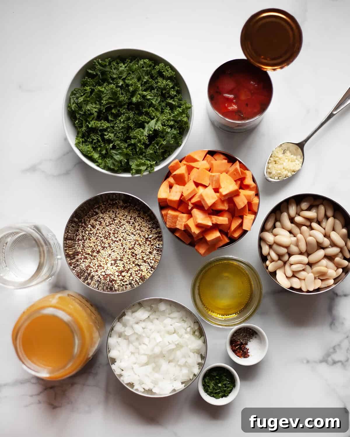 Sweet Potato White Bean Quinoa Bowl 3 Collection of fresh ingredients for sweet potato white bean quinoa soup: quinoa, sweet potatoes, white beans, kale, tomatoes, olive oil, onions, broth, and various seasonings.