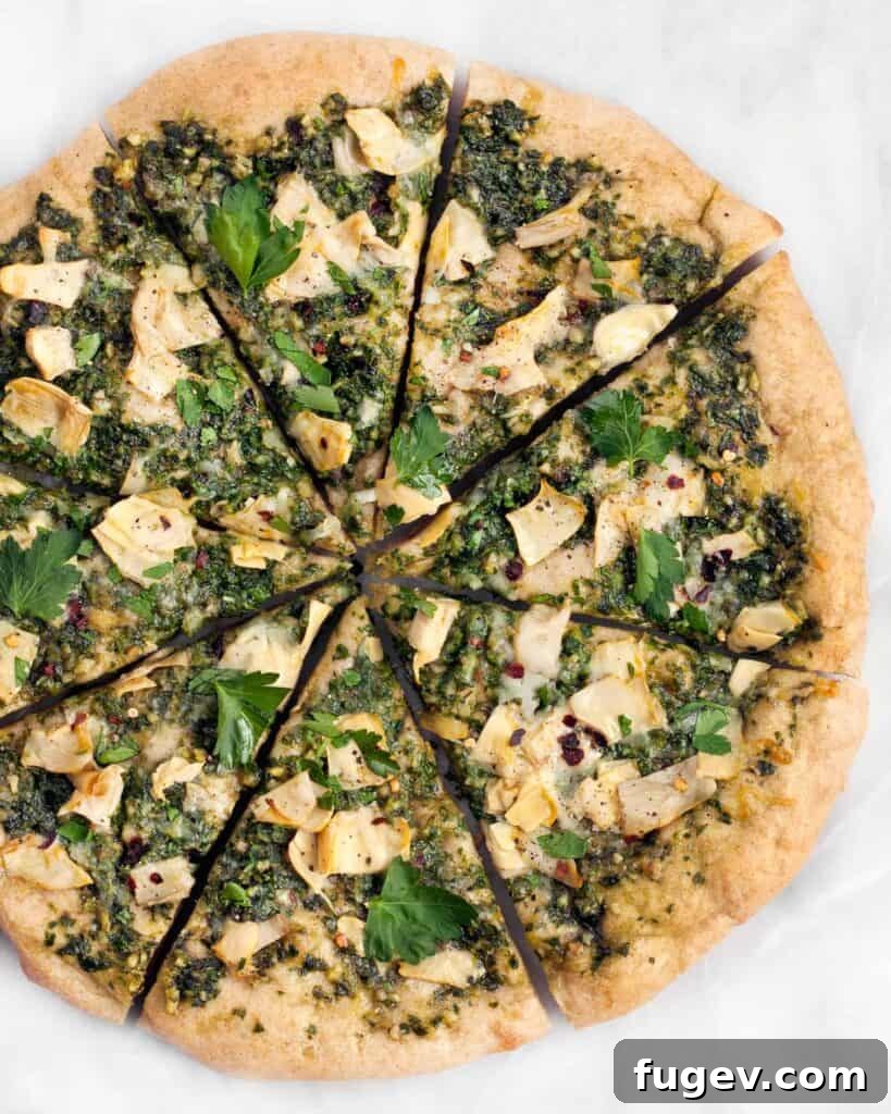 Creamy Spinach Artichoke Pizza 2 Delicious Spinach Artichoke Pizza with vibrant green pesto and melted cheese