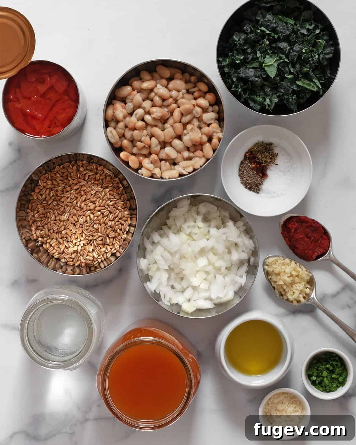 Rustic Tomato White Bean Farro Soup 3 A vibrant flat lay showcasing all the fresh and pantry ingredients needed for tomato white bean farro soup, including tomatoes, farro, white beans, onions, seasonings, olive oil, tomato paste, garlic, and vegetable broth.