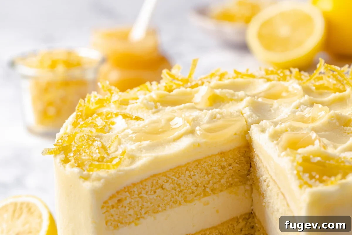 Dreamy Lemon Cloud Frosting 5 Decorated lemon cake sliced open to reveal buttercream layers inside.