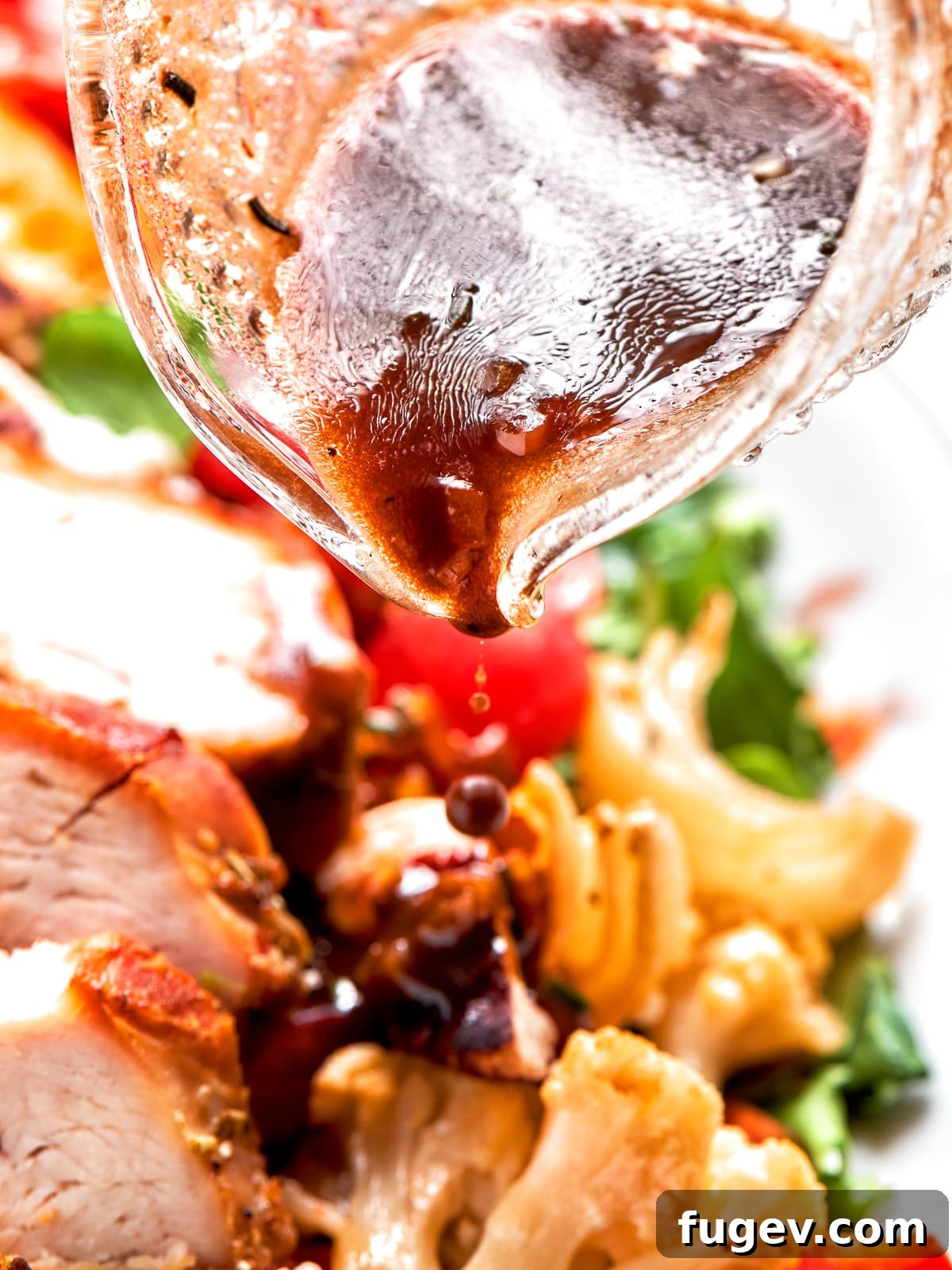 Freshly made lemon balsamic vinaigrette drizzled over mixed greens and succulent chicken breast, ready to be enjoyed.