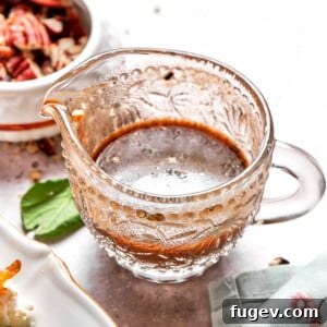 Lemon balsamic vinaigrette served in a clear glass pitcher, showcasing its rich color and smooth texture.