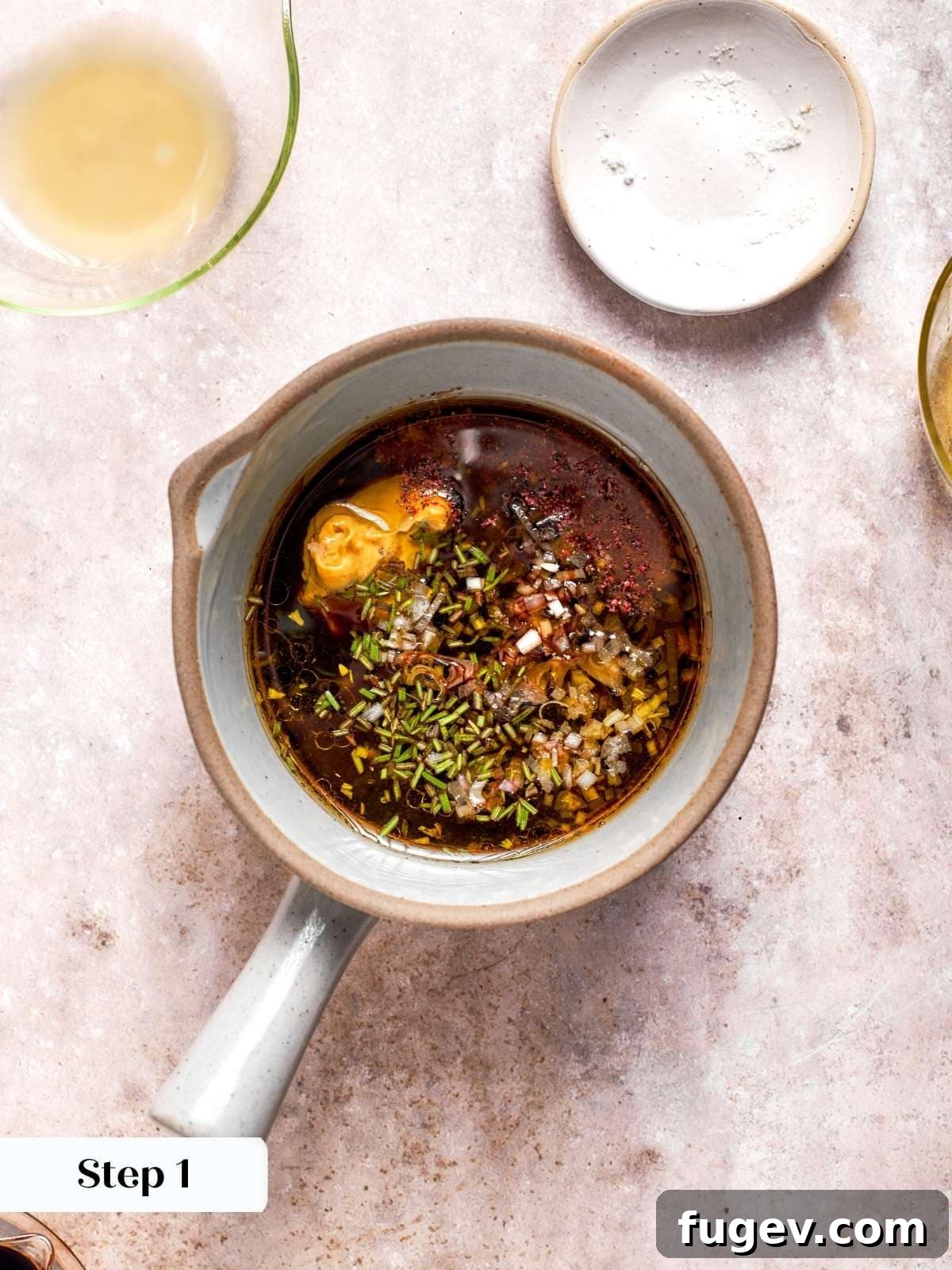 Balsamic vinegar, fresh lemon juice, Dijon mustard, and minced shallot precisely measured in a glass measuring cup, forming the aromatic base of the vinaigrette.