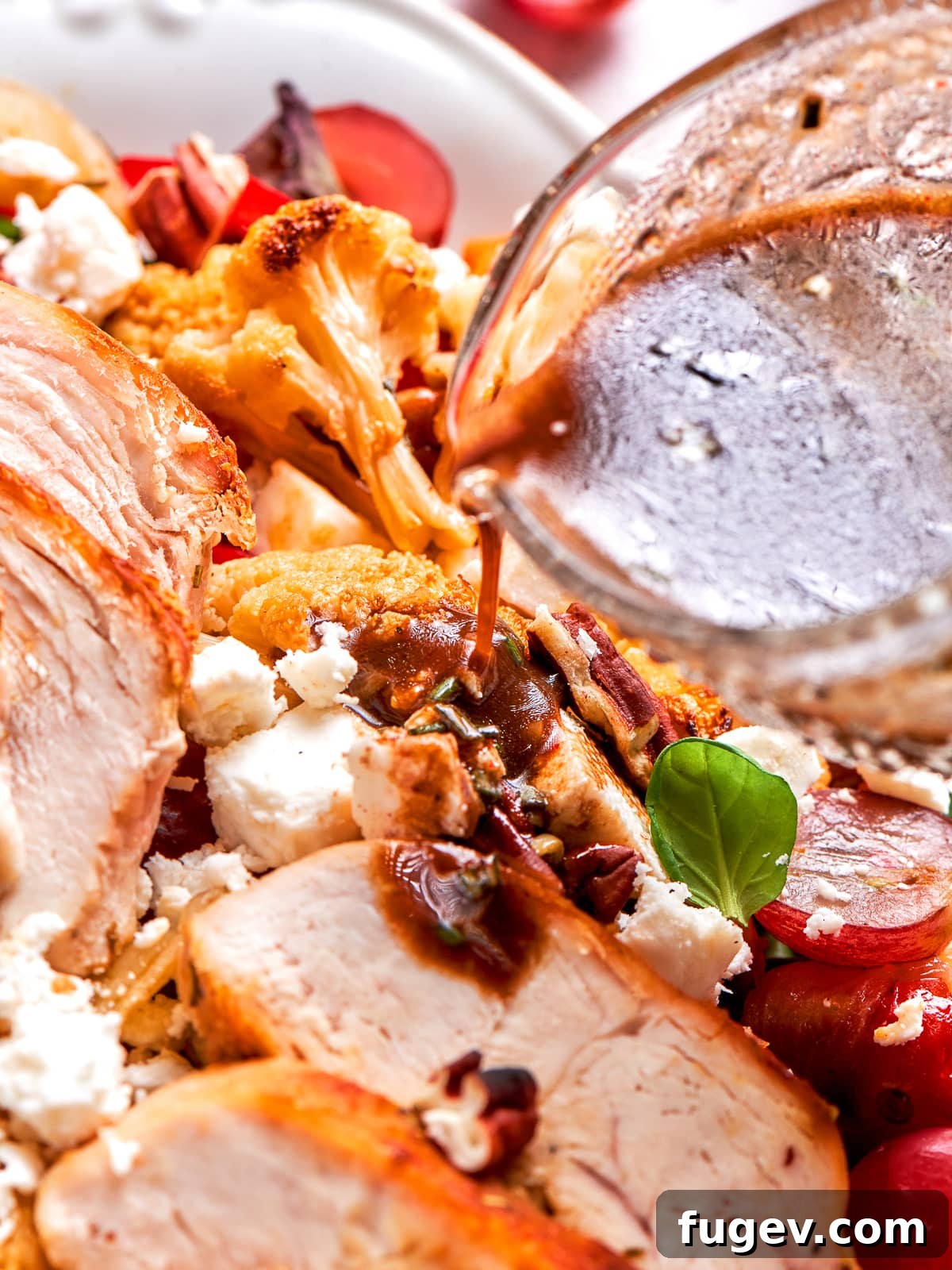 Perfectly cooked golden chicken breast beautifully drizzled with the tangy homemade lemon balsamic dressing, ready for serving.