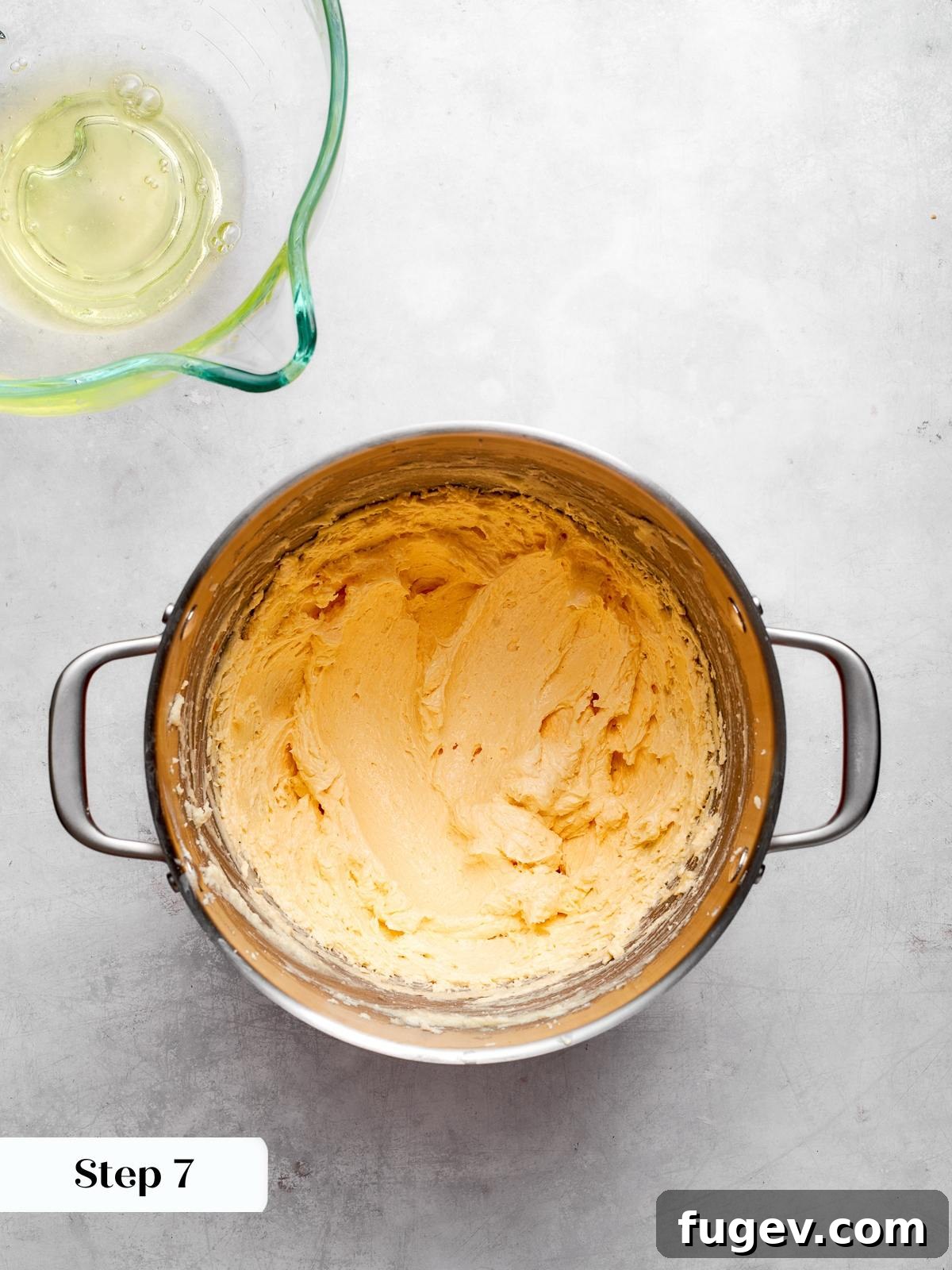 Decadent German Chocolate Cake 12 Pale cake batter prepared and waiting for the melted chocolate to be added, showcasing its smooth and creamy texture.