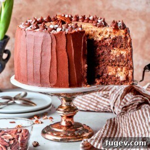 Cake server lifting a slice of perfectly layered German chocolate cake from the dessert, showcasing its tender crumb and rich fillings.