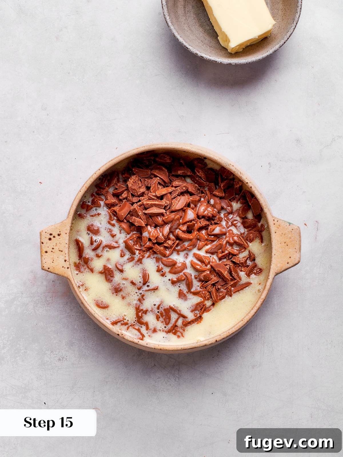Decadent German Chocolate Cake 21 Heavy cream warming in a saucepan, a crucial step in preparing the smooth and rich ganache filling for the cake.