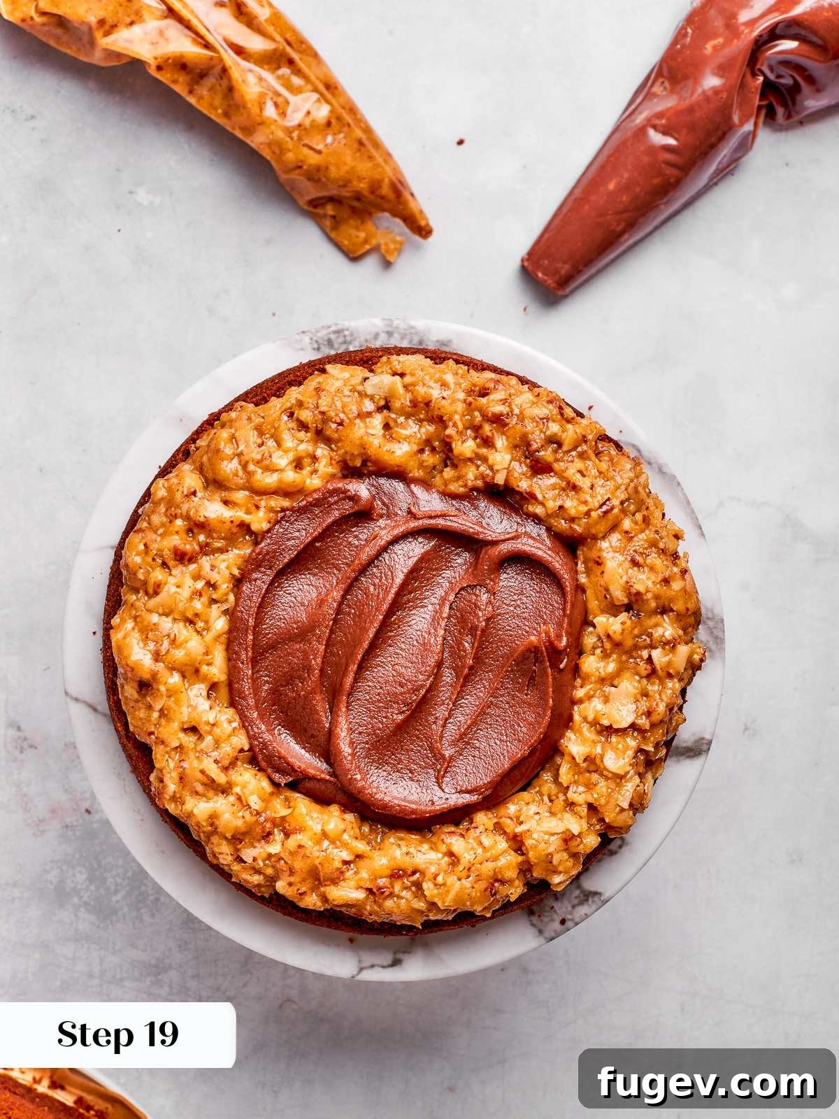 Decadent German Chocolate Cake 24 Smooth chocolate ganache spread perfectly inside the coconut pecan frosting dam between layers of German chocolate cake.