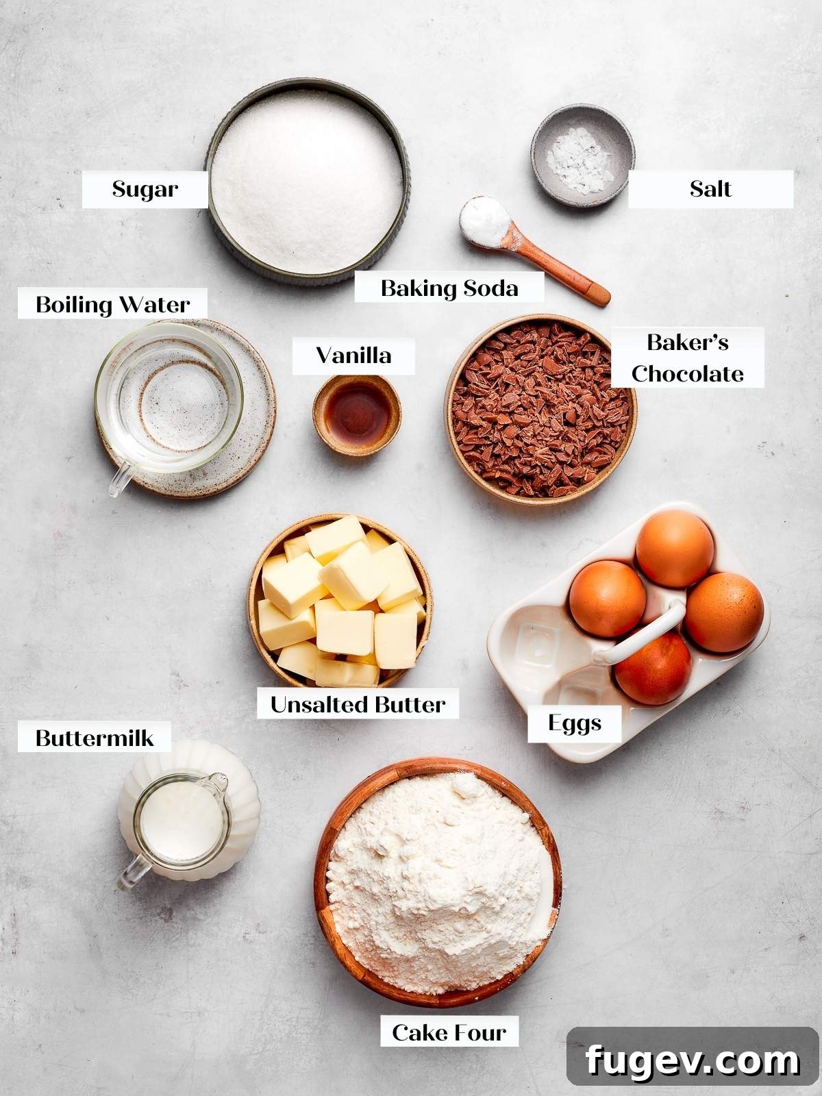 Decadent German Chocolate Cake 4 German chocolate cake ingredients laid out on a clean white countertop, ready for baking.