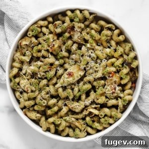 Artichoke pasta with spinach pesto in a bowl, ready to serve.