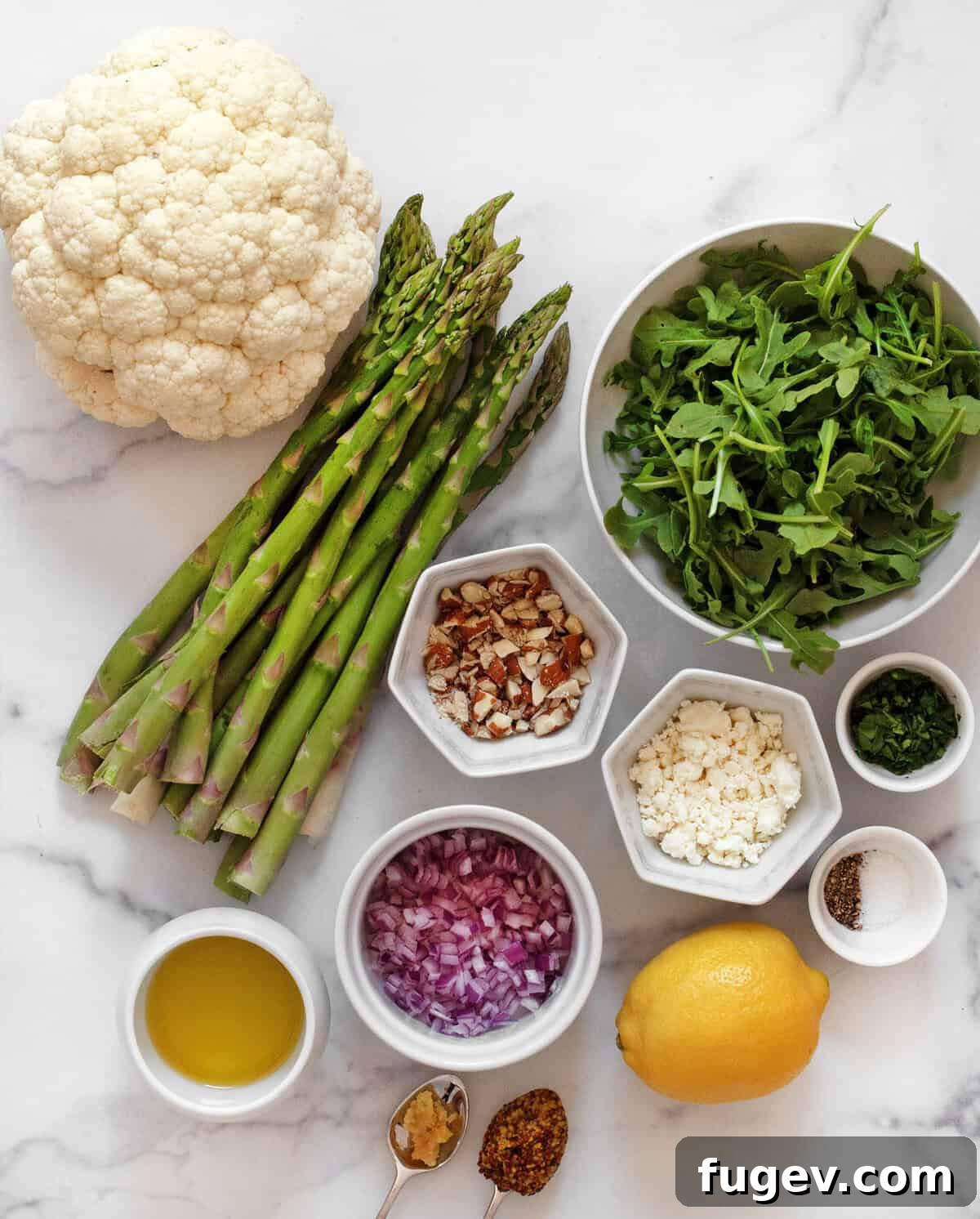 Golden Roasted Asparagus and Cauliflower Delight 3 Ingredients for roasted asparagus cauliflower salad including cauliflower, asparagus, arugula, almonds, goat cheese, red onions, lemon, olive oil, parsley, garlic, mustard, salt and pepper.