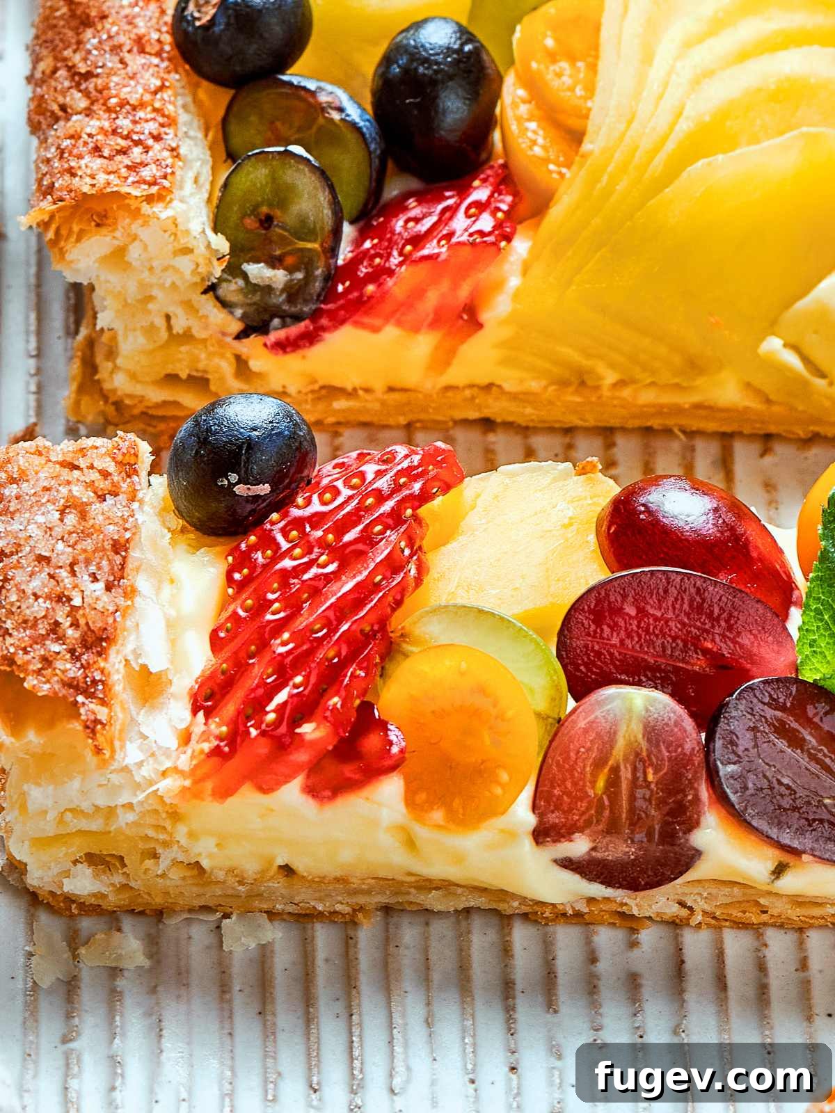 Thick pastry cream spread under sliced fruit, forming a rich filling for tarts.