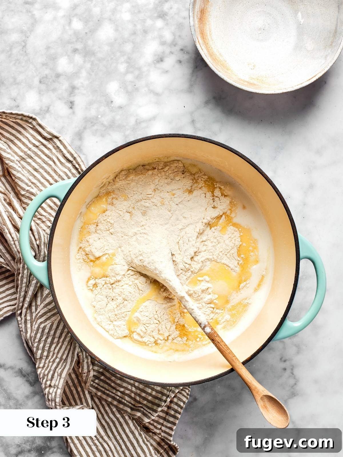 All-purpose flour mixture being added all at once to the hot butter and milk in a pot, initiating the panade process for choux pastry.